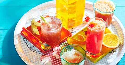 tropical_sparkler-and-peachy-sunrise-mocktail-drinks tropical sparkler and peachy sunrise mocktail drinks on a white round serving platter