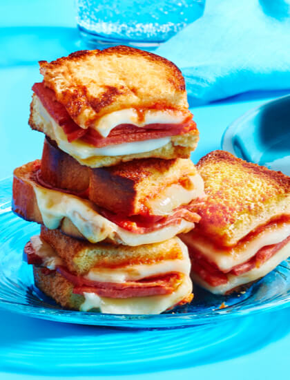 GrilledCheese5Ways Salsa grilled cheese sandwich, pizza grilled cheese sandwich, ad corn-herb grilled cheese sandwich on blue plates