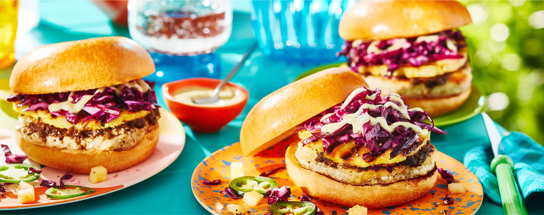 _9Unique_burger sauce ideas Caribbean inspired burger on orange plate.